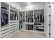 A spacious walk-in closet with custom white shelving, drawers, and ample hanging space at 2560 E Thornton Ct, Gilbert, AZ 85297