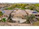 Aerial view showing the house's backyard, a patio, and surrounding landscape at 27831 N Makena Pl, Peoria, AZ 85383