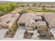 Aerial view of a house with solar panels and a golf course in the background at 27831 N Makena Pl, Peoria, AZ 85383