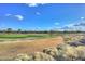 Scenic view of a lush green golf course with homes in the background at 27831 N Makena Pl, Peoria, AZ 85383