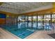 Indoor lap pool with large windows and modern amenities at 27831 N Makena Pl, Peoria, AZ 85383