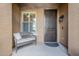 Front porch with a wicker settee and a dark brown door at 2803 E Cobalt St, Chandler, AZ 85225