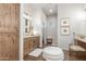 Spa-like bathroom with wood cabinets, granite countertop and a large mirror at 2809 W Paso Nuevo Dr, Phoenix, AZ 85086