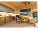 Outdoor kitchen with built-in grill, seating area, and ceiling fan at 2809 W Paso Nuevo Dr, Phoenix, AZ 85086