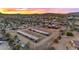 Aerial view of property at sunset with horse stables at 32905 N 140Th St, Scottsdale, AZ 85262