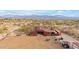 Aerial view of a ranch property with barn, arena, and horses, mountains in the background at 32905 N 140Th St, Scottsdale, AZ 85262