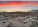 Aerial view of property at sunset, showing main house and stables at 32905 N 140Th St, Scottsdale, AZ 85262