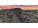 Aerial view of a desert landscape with houses and distant mountains at 32905 N 140Th St, Scottsdale, AZ 85262