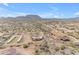 Aerial view of a sprawling ranch property with a main house, stables, and scenic desert landscape at 32905 N 140Th St, Scottsdale, AZ 85262