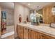 Bathroom with a shower/tub combo and wood cabinets at 32905 N 140Th St, Scottsdale, AZ 85262