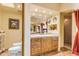 Bathroom with double sinks, wood cabinets, and shower at 32905 N 140Th St, Scottsdale, AZ 85262