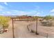 Ranch entrance with a rustic wooden sign and a long driveway at 32905 N 140Th St, Scottsdale, AZ 85262