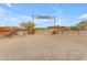 Ranch entrance with a rustic sign and a view of the main house at 32905 N 140Th St, Scottsdale, AZ 85262