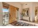 Inviting entry with wood door, large mirror, and decorative rug at 32905 N 140Th St, Scottsdale, AZ 85262