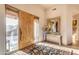 Elegant entryway with a large wood door and ornate mirror at 32905 N 140Th St, Scottsdale, AZ 85262