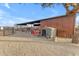 Exterior view of barn with dog house and red chairs at 32905 N 140Th St, Scottsdale, AZ 85262