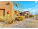 Brick pathway leads to a stucco home with a wooden door and desert landscaping at 32905 N 140Th St, Scottsdale, AZ 85262