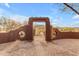 Rustic entryway with a wooden arch and brick paving, offering scenic views at 32905 N 140Th St, Scottsdale, AZ 85262