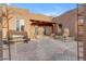 Courtyard entry with a wooden door, brick flooring, and a stone fountain at 32905 N 140Th St, Scottsdale, AZ 85262