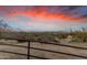 View of a ranch fence with a scenic desert background and sunset at 32905 N 140Th St, Scottsdale, AZ 85262