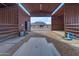 View through the horse stable to the large outdoor area at 32905 N 140Th St, Scottsdale, AZ 85262