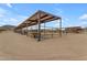 Covered horse stables with multiple stalls and water troughs at 32905 N 140Th St, Scottsdale, AZ 85262