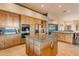 Kitchen boasts wood cabinets, granite island, and stainless steel appliances at 32905 N 140Th St, Scottsdale, AZ 85262