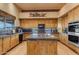 Island kitchen with granite countertops and stainless steel appliances at 32905 N 140Th St, Scottsdale, AZ 85262