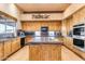 Gourmet kitchen with wood cabinets, granite counters, and stainless appliances at 32905 N 140Th St, Scottsdale, AZ 85262