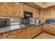 Kitchen with wood cabinets, granite countertops and stovetop at 32905 N 140Th St, Scottsdale, AZ 85262