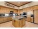 Open kitchen with wood cabinets, granite countertops and island at 32905 N 140Th St, Scottsdale, AZ 85262