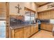 Rustic kitchen with wood cabinets, granite countertops, and a view to the backyard at 32905 N 140Th St, Scottsdale, AZ 85262