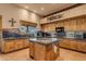 Island kitchen with granite countertops and wooden cabinets at 32905 N 140Th St, Scottsdale, AZ 85262