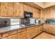 Kitchen features wood cabinets, granite countertops and stovetop at 32905 N 140Th St, Scottsdale, AZ 85262