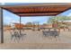 Covered patio with metal table and chairs, ideal for outdoor dining at 32905 N 140Th St, Scottsdale, AZ 85262