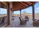 Covered patio with wicker chairs and brick flooring at 32905 N 140Th St, Scottsdale, AZ 85262