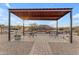 Relaxing patio area with metal table and chairs under a pergola at 32905 N 140Th St, Scottsdale, AZ 85262