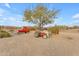 Ranch yard with vintage farm vehicles and desert landscaping at 32905 N 140Th St, Scottsdale, AZ 85262