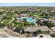 A vibrant aerial view captures a community pool, splash pad, park, playground, and nearby community building at 330 S San Fernando Ln, Casa Grande, AZ 85194