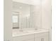 Bright bathroom featuring a double sink vanity with white cabinets and a large mirror at 330 S San Fernando Ln, Casa Grande, AZ 85194