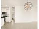 Bright dining area featuring modern light fixture and easy access to the open-concept kitchen with stainless steel appliances at 330 S San Fernando Ln, Casa Grande, AZ 85194