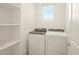 Bright laundry room features shelving and a modern washer and dryer at 330 S San Fernando Ln, Casa Grande, AZ 85194