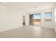 Living room featuring neutral paint, tile floors, lots of natural light from sliding glass doors, and access to a large backyard at 330 S San Fernando Ln, Casa Grande, AZ 85194