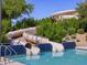 Community water park featuring three slides leading to a sparkling blue swimming pool at 330 S San Fernando Ln, Casa Grande, AZ 85194