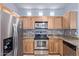 Modern kitchen with wood cabinets and stone backsplash at 34619 N 30Th Ave, Phoenix, AZ 85086