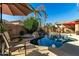 Relaxing backyard pool area featuring lounge chairs, patio, and waterfall at 3559 E Bridgeport Pkwy, Gilbert, AZ 85295