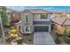 Two-story house with a green garage door and solar panels at 3617 E Half Hitch Pl, Phoenix, AZ 85050