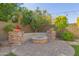 Landscaped backyard with fire pit and stone seating at 3617 E Half Hitch Pl, Phoenix, AZ 85050