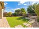 Large backyard with artificial turf and stone pathway at 3617 E Half Hitch Pl, Phoenix, AZ 85050