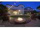 Fire pit and seating area in backyard at night at 3617 E Half Hitch Pl, Phoenix, AZ 85050